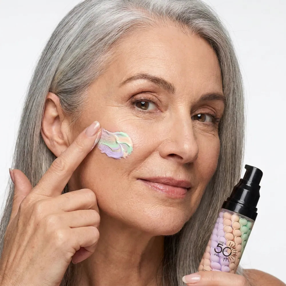Woman applying the triple-action color corrector